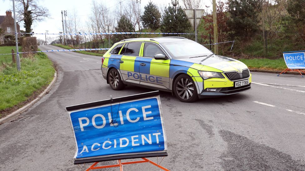 Police car and tape at scene of Ballynahonemore Road crash