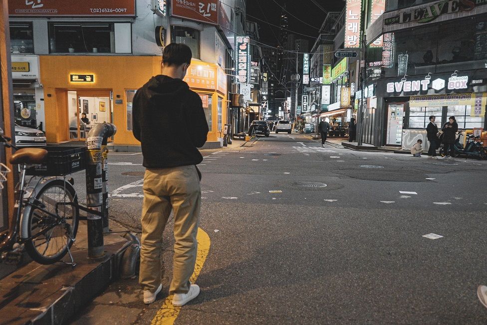 Mr Kim stands on a street corner in Seoul