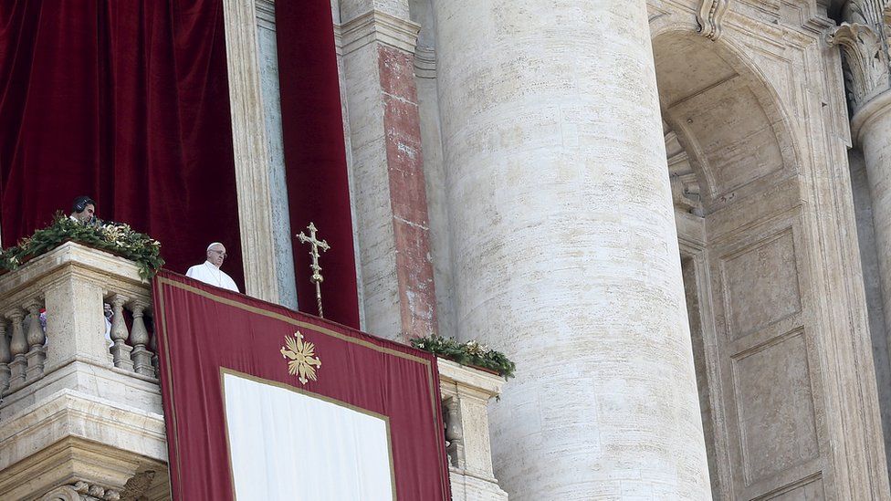 Pope Francis delivers a Christmas speech from the balcony overlooking St Peter's Square