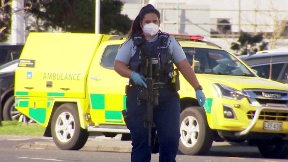 An armed police officer at the site of a knife attack in Auckland, New Zealand. Photo: 3 September 2021