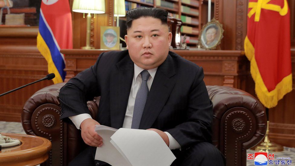 Kim Jong-un in an armchair giving his New Year's speech