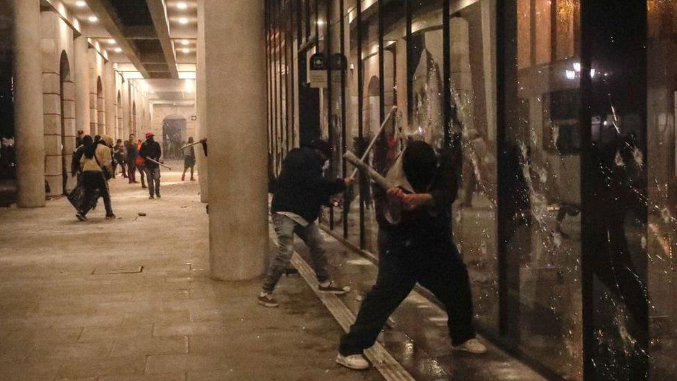 People vandalize buildings during a protest in Guatemala City, Guatemala, 09 October 2023.