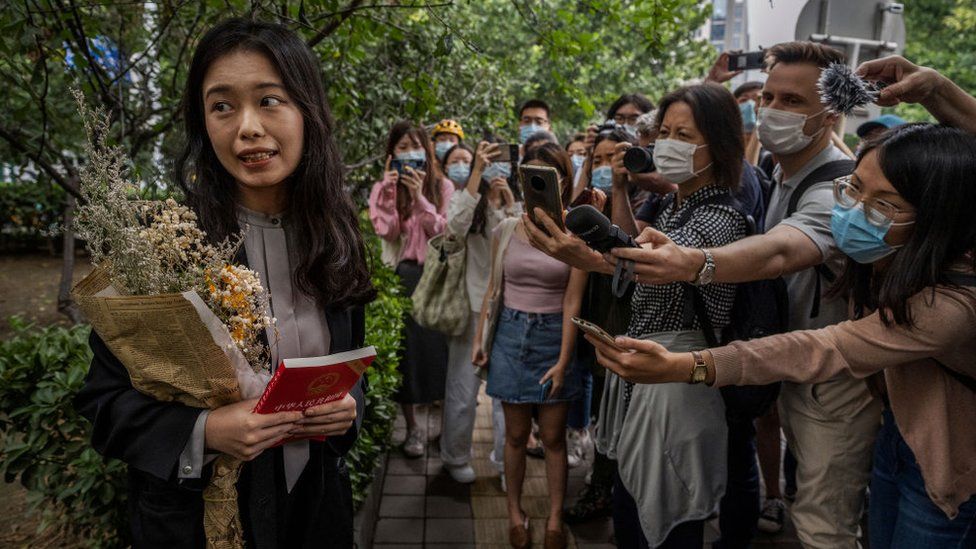 Leading figure in China's #MeToo movement Zhou Xiaoxuan, known also as Xianzi, left, speaks to journalists and supporters outside the Haidian District People's Court before a hearing in her case against prominent television host Zhu Jun on September 14, 2021 in Beijing, China.