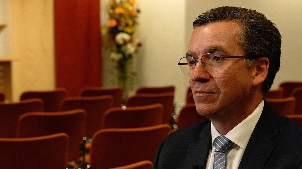 Hamburg Jehovah's Witnesses community representative Michael Tsifidaris sitting in an empty meeting hall