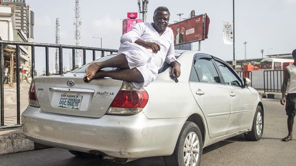 A may lying on his car on Lagos Island, Lagos, Nigeria - Monday 27 February 2023