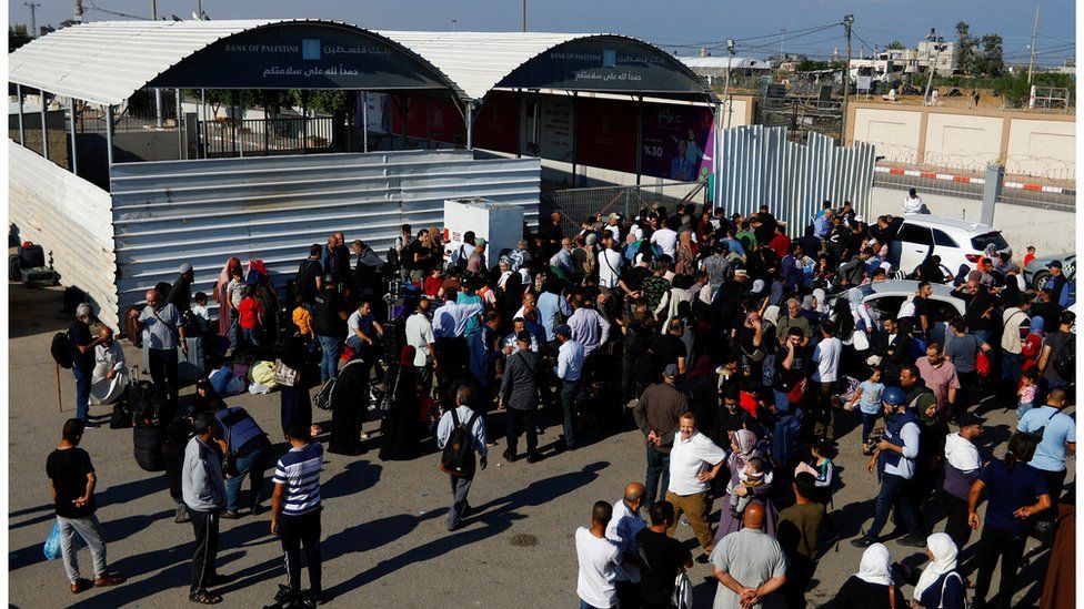 Palestinians gather outside the Rafah border crossing with Egypt