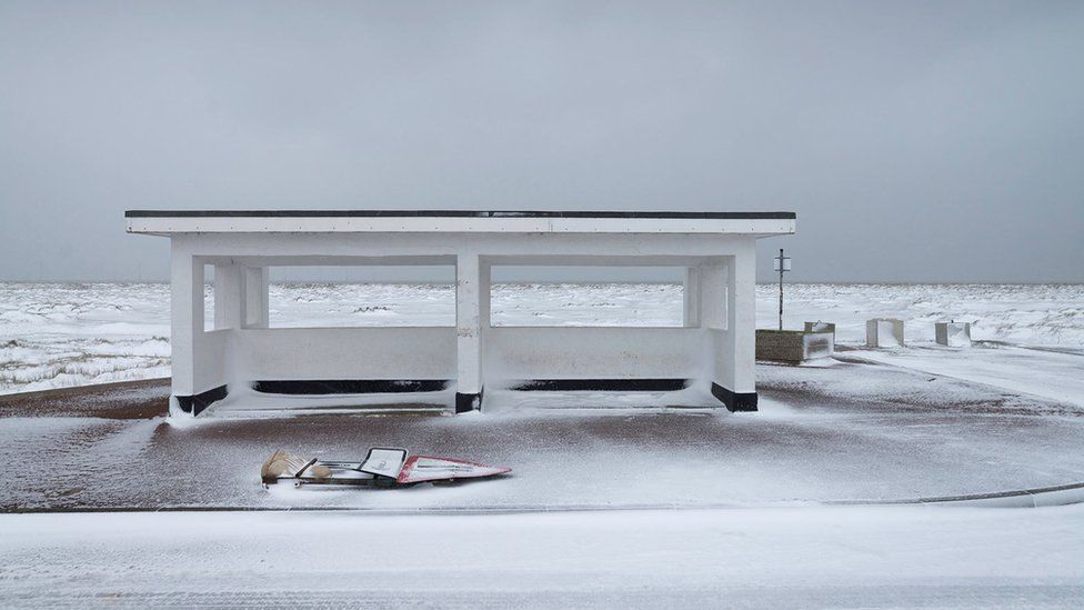 A Great Yarmouth seafront shelter lightly covered in snow
