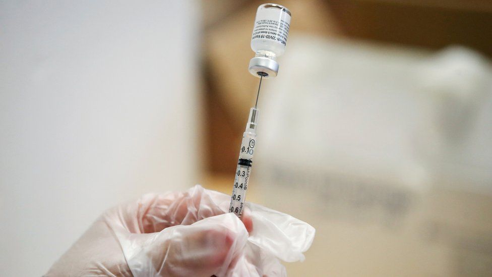 Doctor prepares a dose of the Pfizer-BioNTec vaccine against coronavirus disease