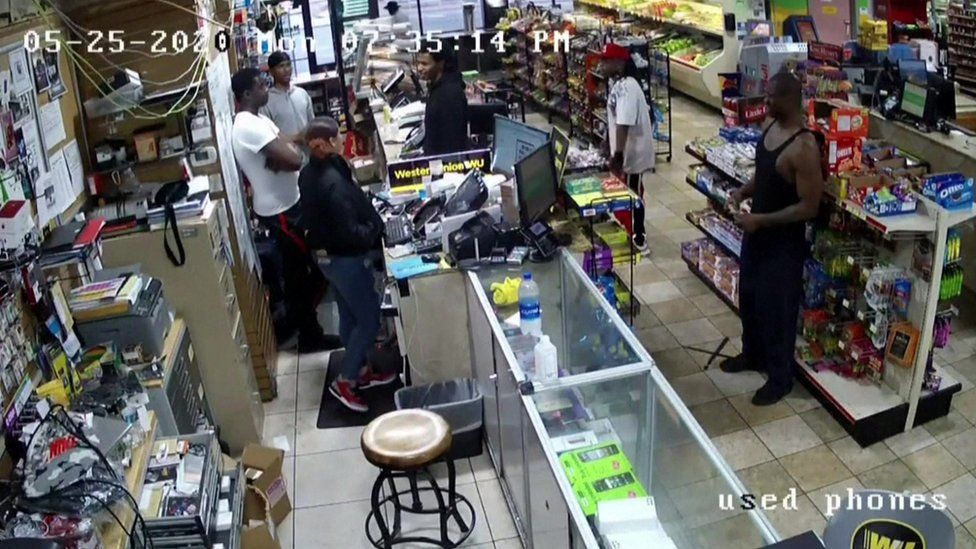 George Floyd is seen in security camera footage in a grocery store