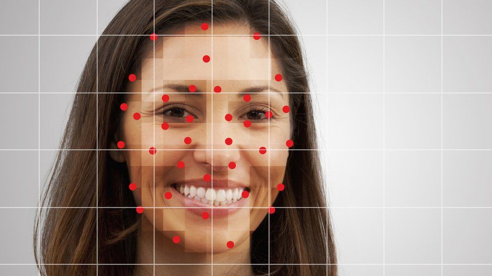 A woman being checked by a facial recognition system