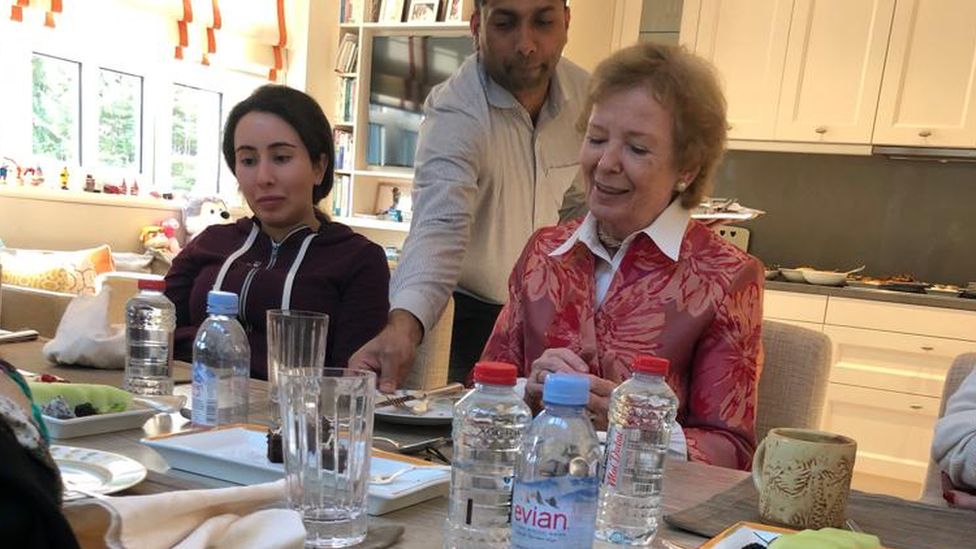 Sheikha Latifa is photographed alongside Mary Robinson being served at a table