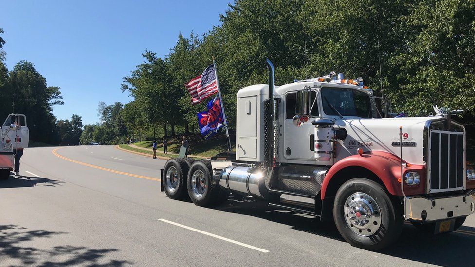 Truck with flags driving along a road in Virginia