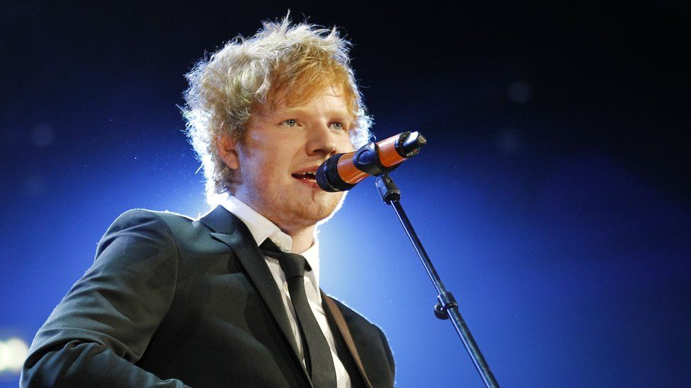 Ed Sheeran singing on stage