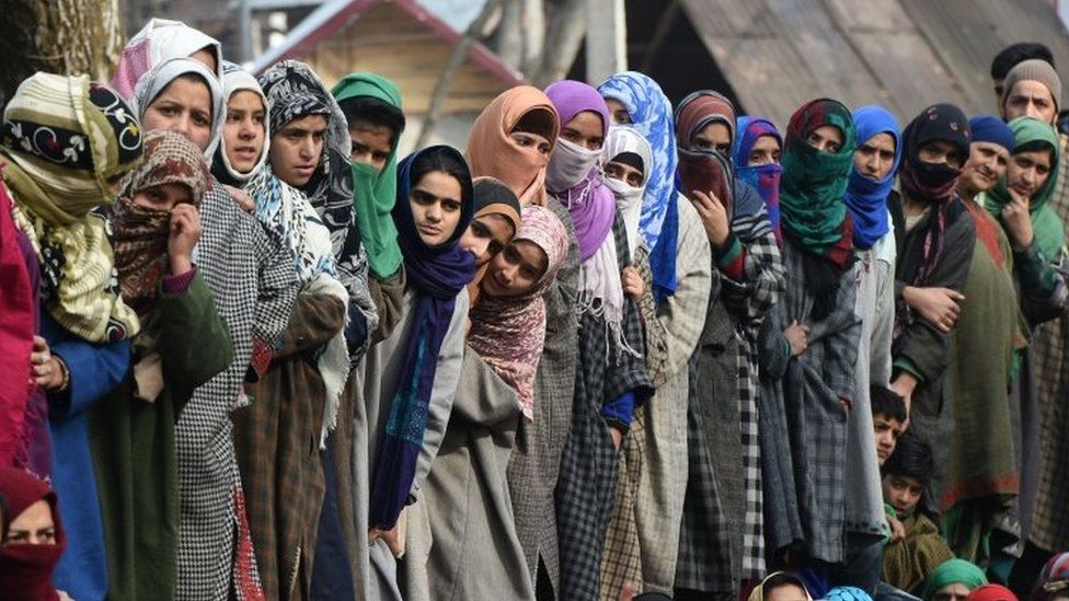 Kashmiri villagers look on during the funeral of militant commander Noor Mohammad Tantray in the Aripal village of Tral district on December 26, 2017.