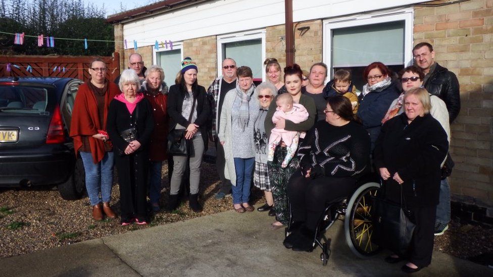 People standing in front of a house