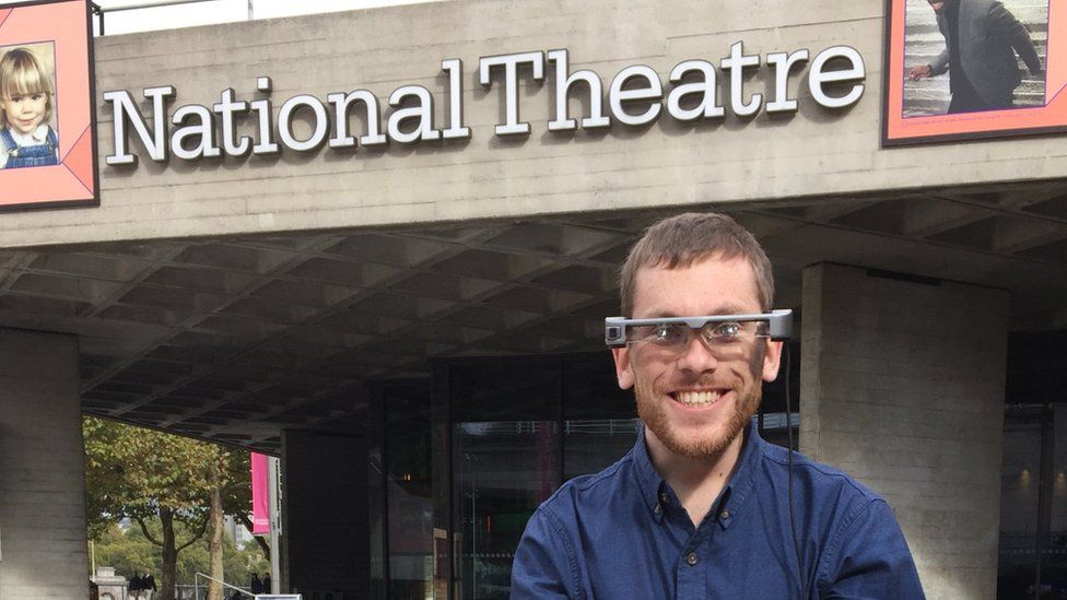 Ellis Palmer in smart captioning glasses outside the National Theatre in London