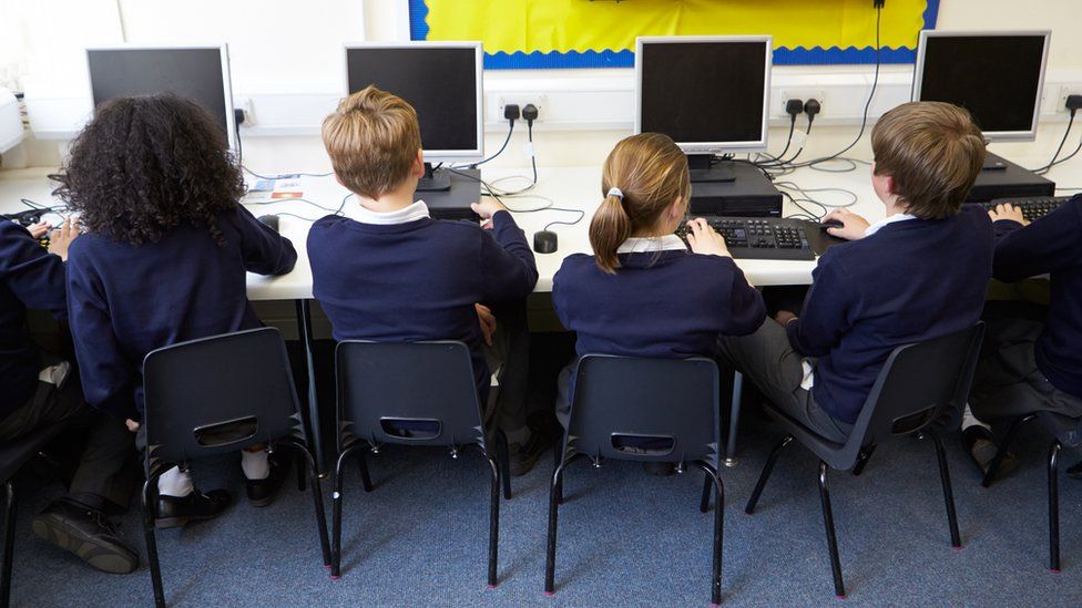 Children in school computer class