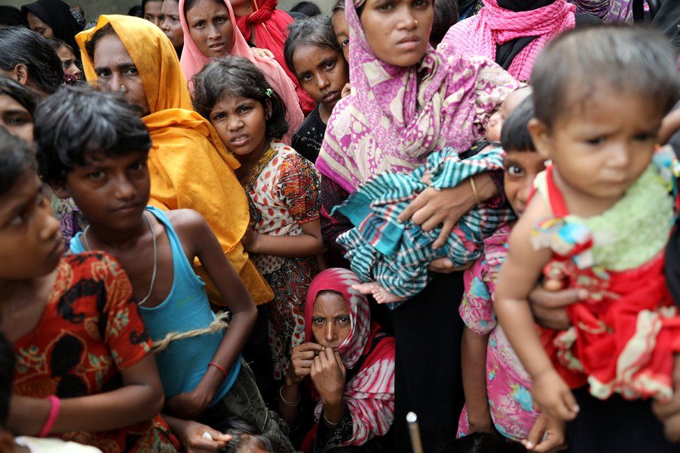 Rohingya refugees wait for humanitarian aid to be distributed at the Balu Khali refugee camp in Cox's Bazar, Bangladesh 5 October 2017.