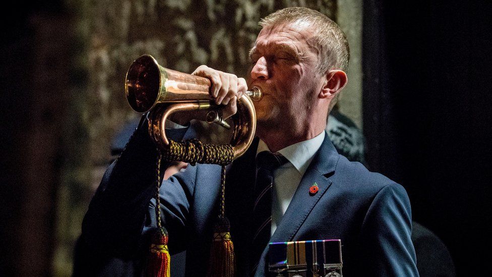 Bugler Noel Trimble plays The Last Post during a dawn Armistice Day ceremony at Enniskillen Castle in County Fermanagh