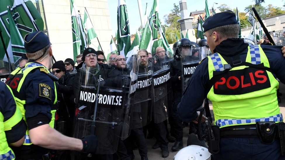 Police officers stop NMR demonstrators from trying to walk along a forbidden street during the Nordic Resistance Movement (NMR) march in central Gothenburg, Sweden September 30, 2017.