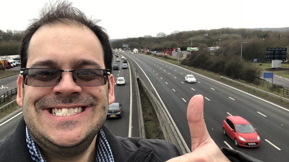 Andrew Warner taking a selfie showing the traffic