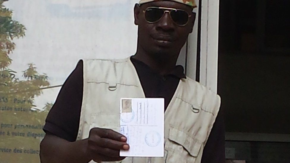 Hadji holding a postcard