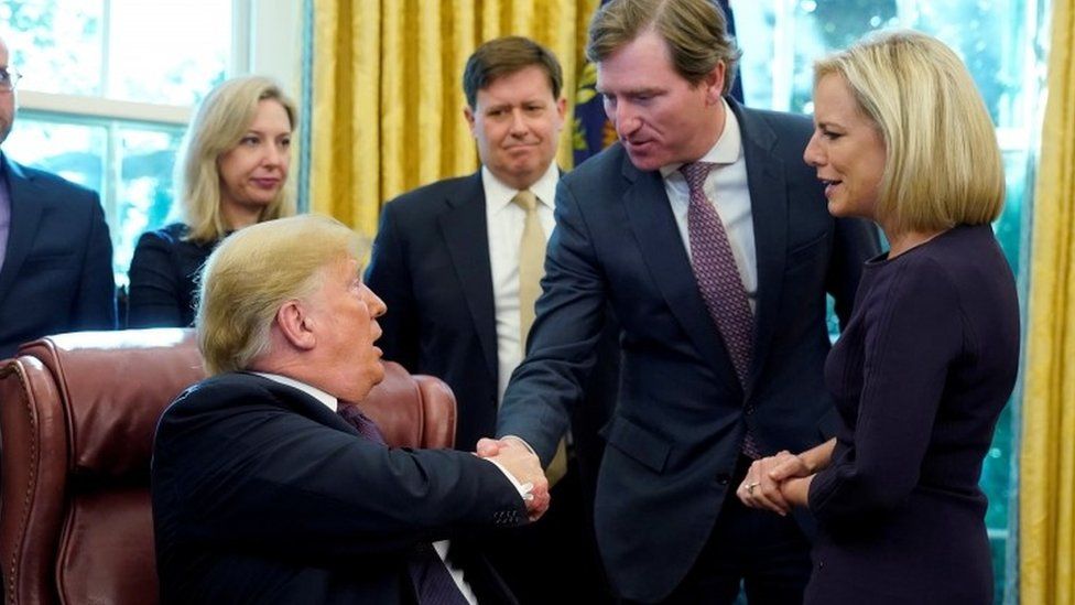 Donald Trump shakes hands with Chris Krebs