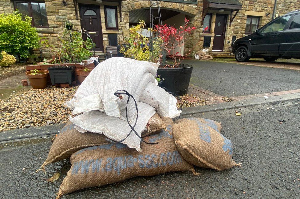 Sand bags piled up outside houses