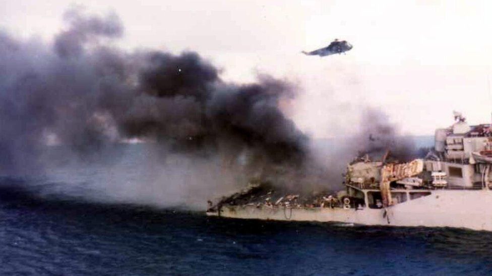 Smoke billows from HMS Ardent after it was hit by Argentine aircraft