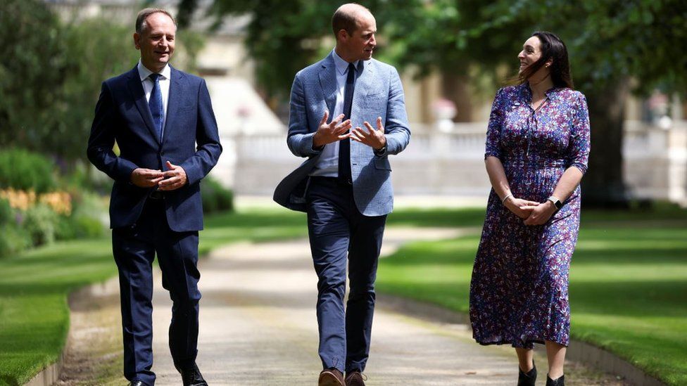 NHS England chief executive Sir Simon Stevens and NHS Charities Together chief executive Ellie Orton walk with Prince William