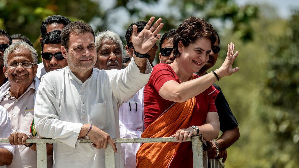 Rahul Gandhi and Priyanka Gandhi wave at the crowd in the road show after Rahul Gandhi filing nominations from Wayanad district on April 4, 2019 in Kalpetta town in Wayanand