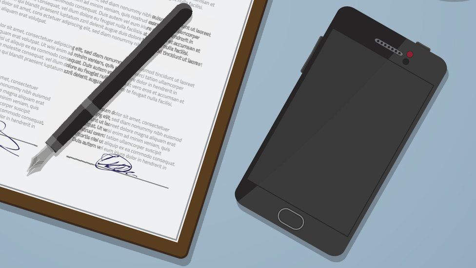 A mobile phone next to a document