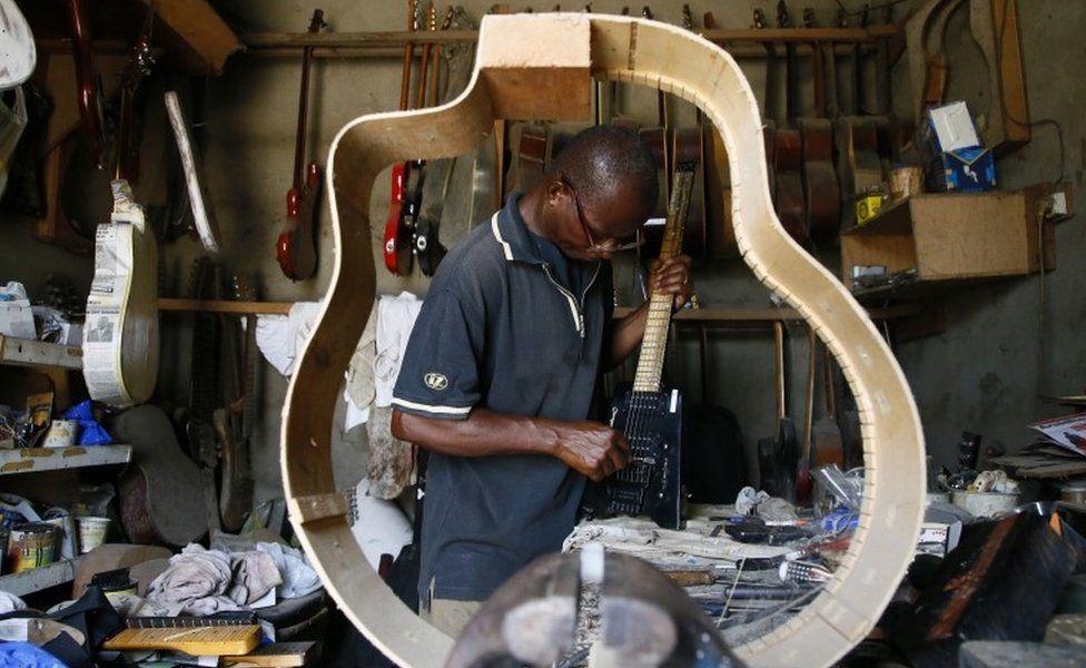 Adicko Pierre, 62, an Ivorian luthier works in his workshop in Abobo, an area of Abidjan, Ivory Coast, 30 September 2020, a day before International Music Day