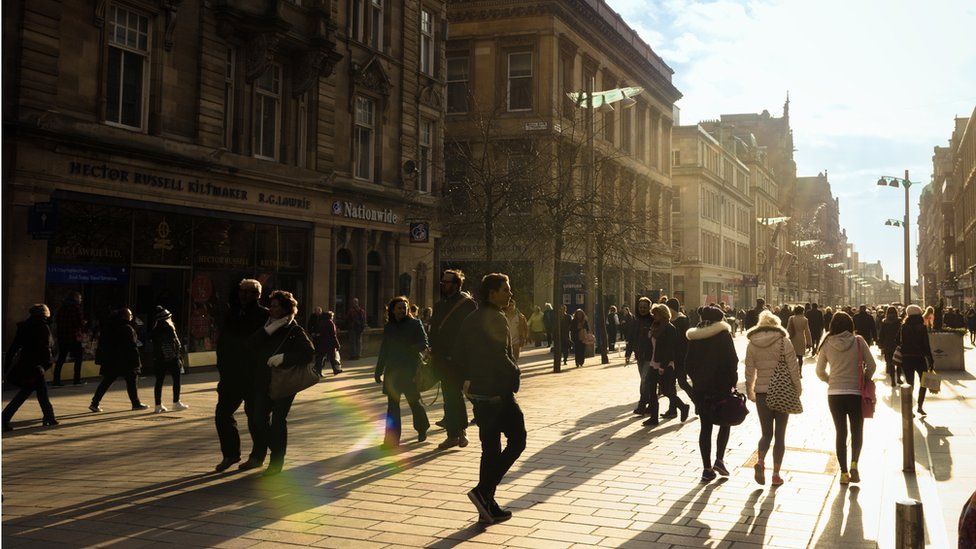 People walking in the sun on Buchanan Street in Glasgow