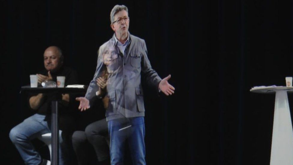 French presidential election candidate Jean-Luc Melenchon delivers a speech via hologram