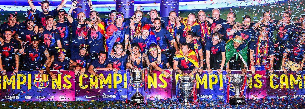 FC Barcelona players celebrate with La Liga, Copa del Rey and Champions League trophies during their victory parade after winning the UEFA Champions League Final at the Camp Nou Stadium on 7 June 2015 in Barcelona, Spain