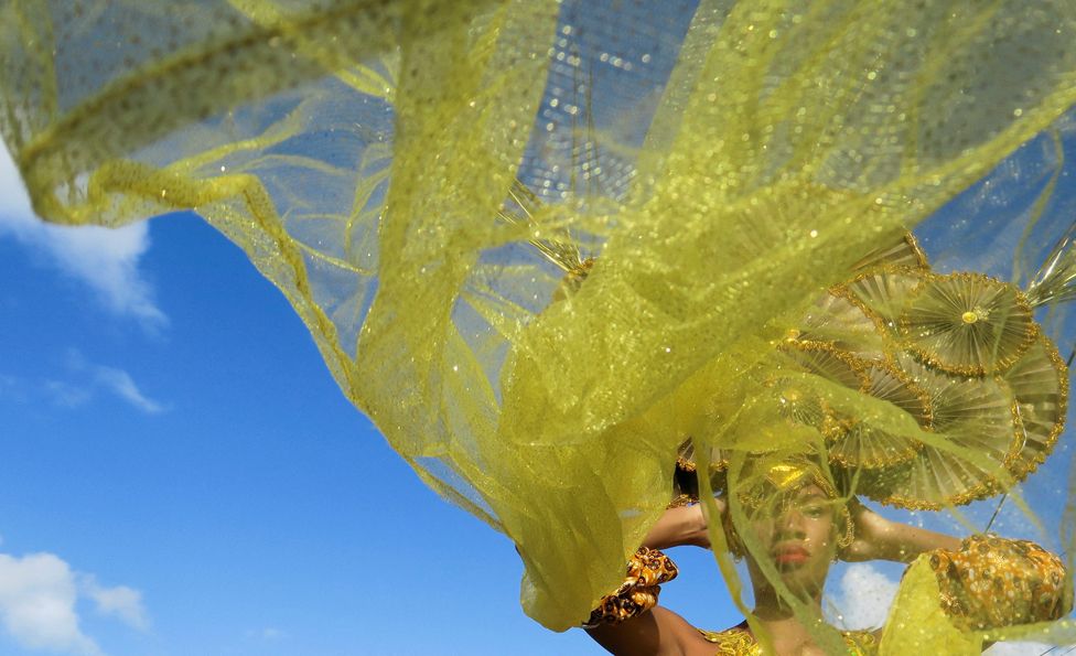 A reveller wears a section  Carnival costume during the parade of "Carnaval de Sainte-Rose" successful  Sainte-Rose, Guadeloupe, January 22, 2022.