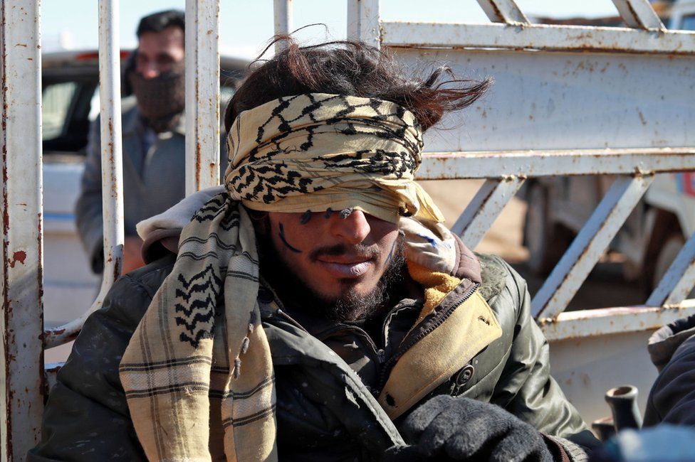 A suspected IS member in detention in the Syrian village of Baghouz, near the Iraqi border, 30 January
