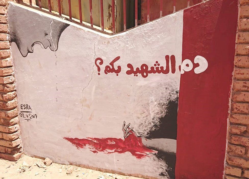 A mural showing a person crying over a bleeding hand with the words: "What is martyrs' blood worth?" - Khartoum, Sudan
