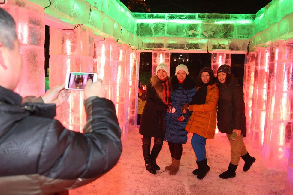 People visit ice sculptures ahead