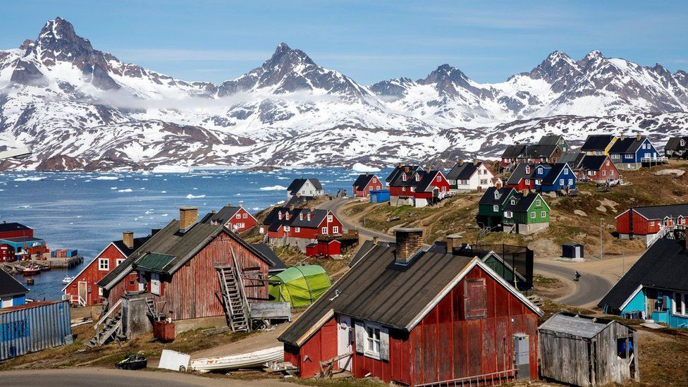 A file photo shows snow covered mountains rise above the harbour and town of Tasiilaq, Greenland, on June 15, 2018.