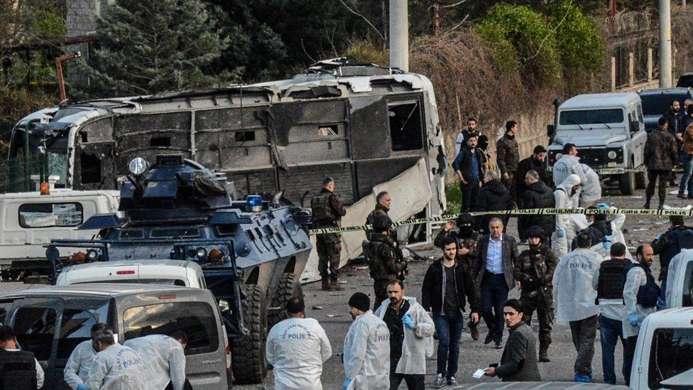 Turkish special force police officers walk at the site of a bomb attack in Diyarbakir, south-eastern Turkey, on March 31, 2016.