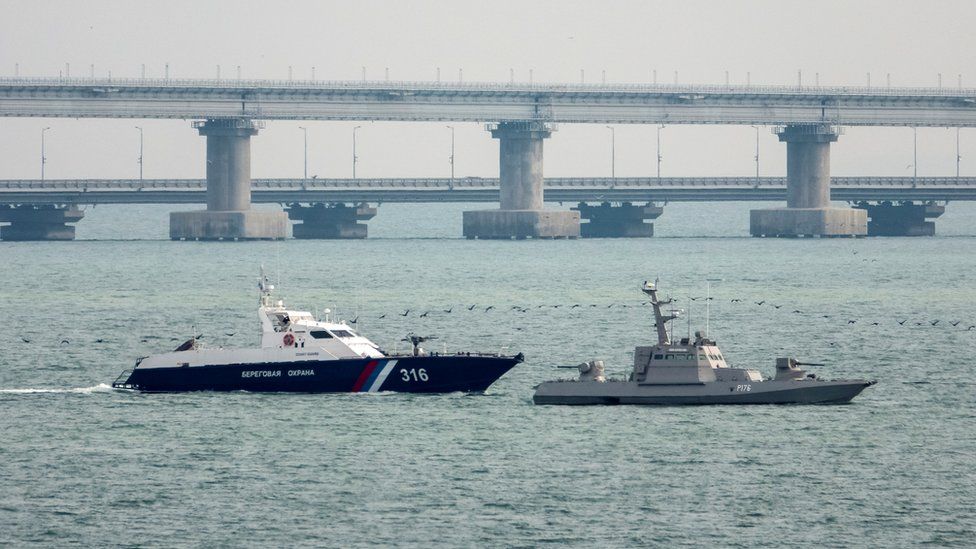A seized Ukrainian ship is towed by a Russian Coast Guard vessel out of the port in Kerch, near the bridge connecting the Russian mainland with the Crimean Peninsula, 17 November 2019