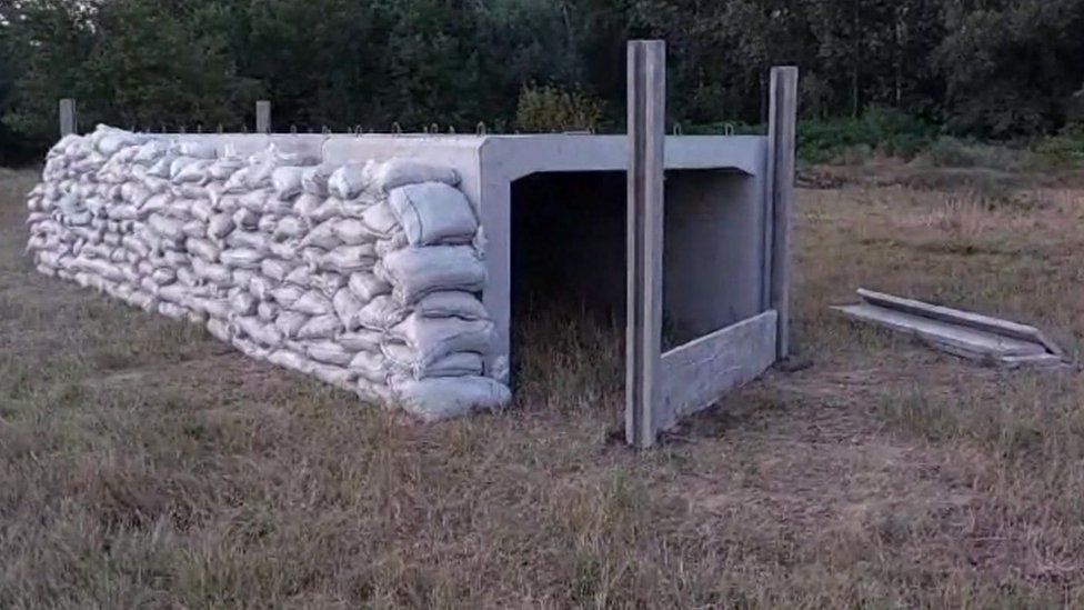A concrete shelter surrounded by sand bags in a Romanian village close to the border