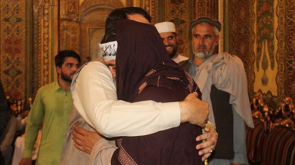 Hayatullah Hayat hugs a member of the Taliban during the June 2018 ceasefire