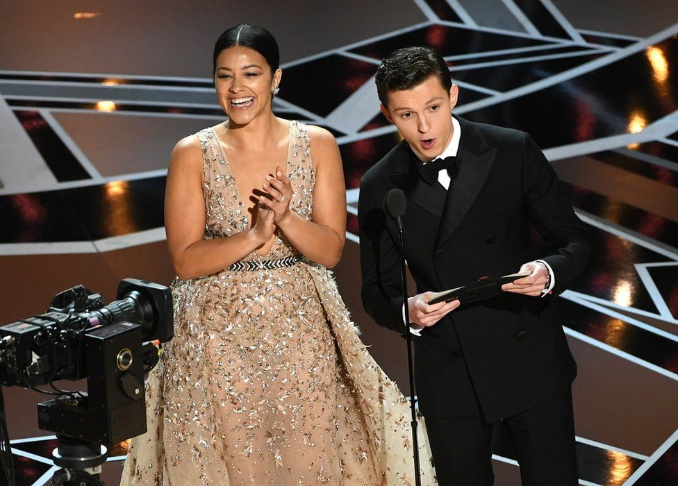 Gina Rodriguez and Tom Holland onstage