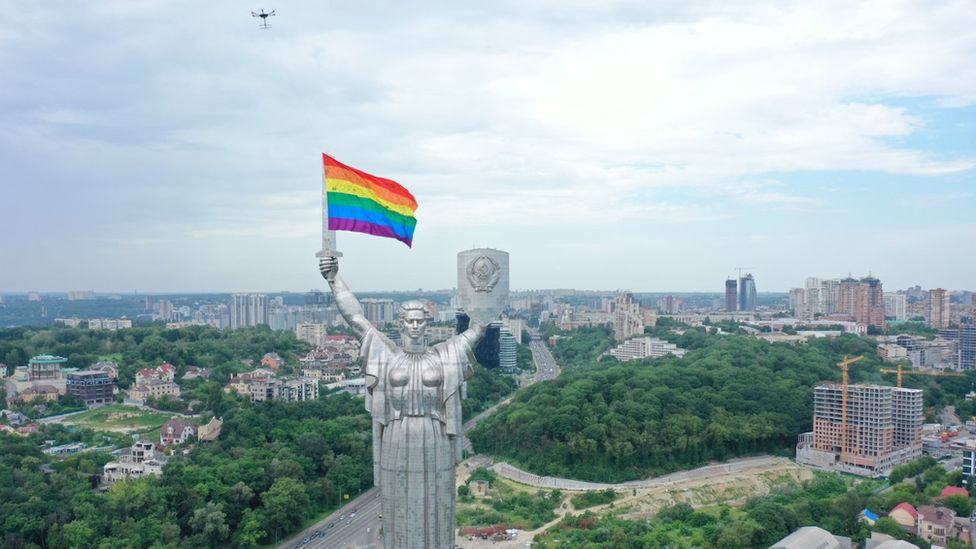 A drone flies an LGBT flag near the Statue of the Motherland in Kyiv, Ukraine