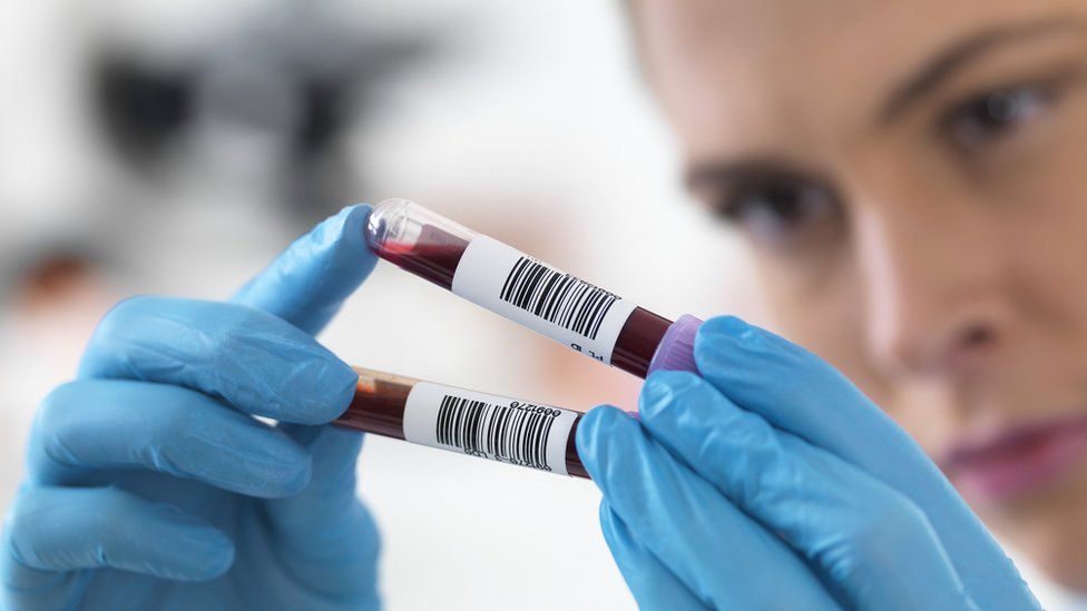 scientist holding blood samples