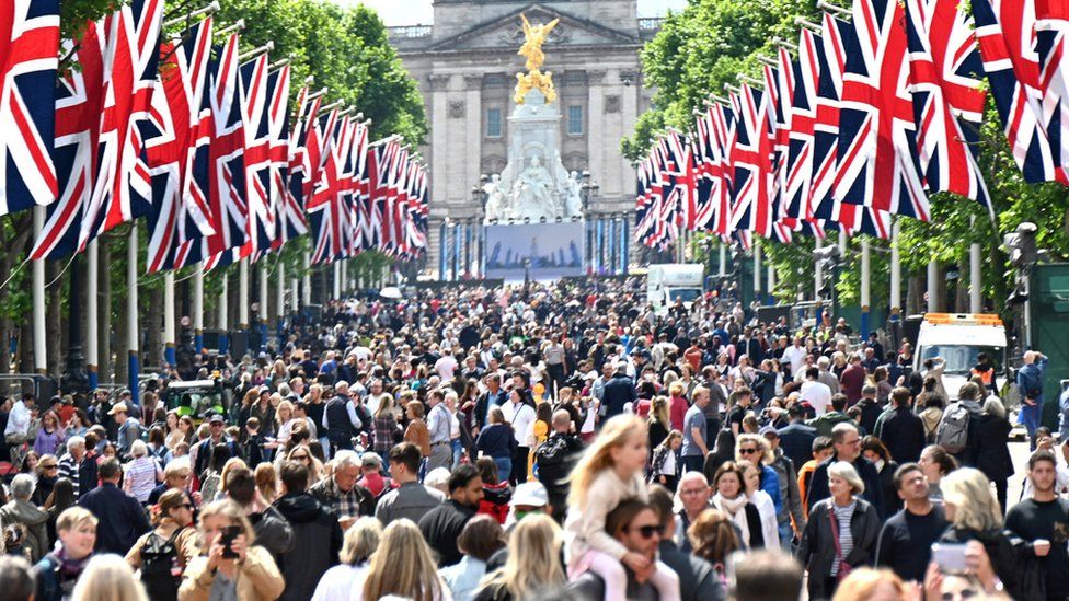 Crowds walk down the Mall leading to Buckingham Palace