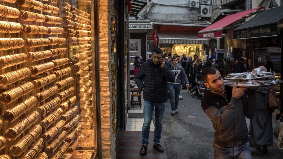 People walk past a gold store in Istanbul